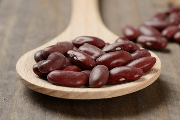 Long purple bean in a wooden spoon