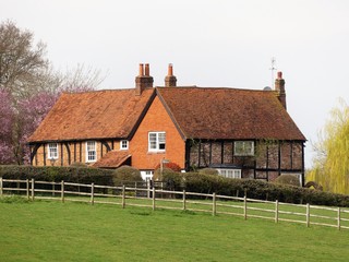 English country farm house surrounded by fields