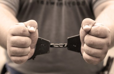 Fototapeta premium Man's hands in handcuffs. crime, arrest, criminal.