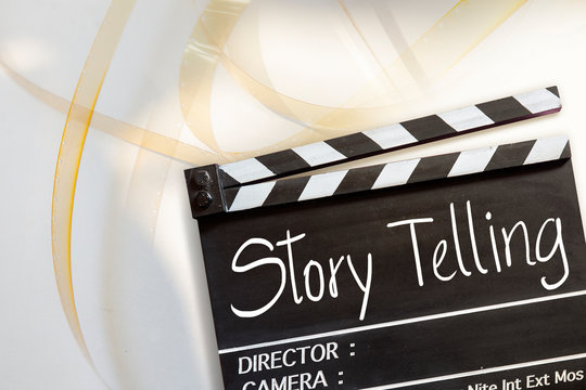 Story telling text title on movie clapper board and 8mm film reel on white background