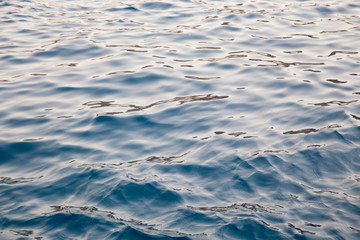Blue clear water. Beautiful blue sea wave photograph close up. Beach vacation at sea or ocean. Background to insert images and text. Tourism, travel.
