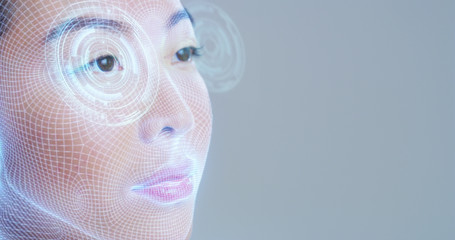 Futuristic and technological scanning of the face of a beautiful woman for facial recognition and scanning to ensure personal safety. 