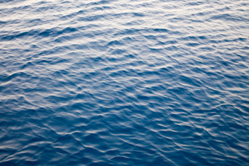 Blue clear water. Beautiful blue sea wave photograph close up. Beach vacation at sea or ocean. Background to insert images and text. Tourism, travel.