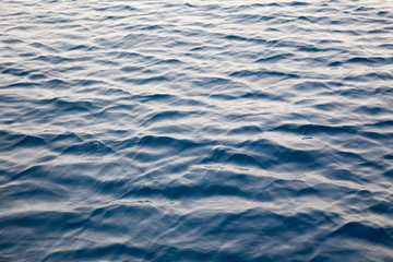 Blue clear water. Beautiful blue sea wave photograph close up. Beach vacation at sea or ocean. Background to insert images and text. Tourism, travel.