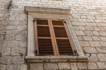 Typical window of an ancient building in the city of Kotos, Montenegro, Europe