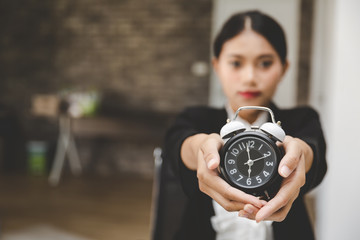 Business woman with alarm clock