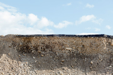Cross section of asphalt road with blue sky background
