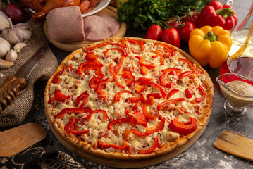 Pizza with ham, chicken and paprika