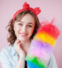 Cleaning pin up woman. Smiling pinup girl holds colorful duster brush. Cleaning service. Pin-up...