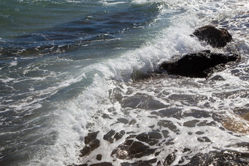 Waves in the ocean. Beautiful blue sea wave photograph close up. Beach vacation at sea or ocean. Background to insert images and text. Tourism, travel.