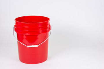 Isolated red bucket on white background.