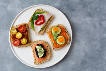 Breakfast toasts with various toppings. Healthy bruschetta. Bread sandwich.