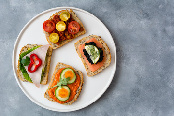 Breakfast toasts with various toppings. Healthy bruschetta. Bread sandwich.