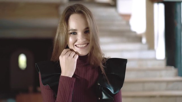 Portrait of young beautiful girl dressed in leather wings, close-up