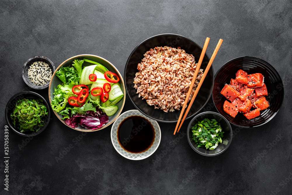 Canvas Prints culinary background of poke bowl ingredients - brown rice, trout or salmon fillet, chuka seaweed sal