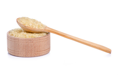 Rice in wooden bowl with wooden spoon on white background isolation