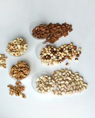 Healthy food. Nuts mix assortment on stone table top view. Collection of different legumes for background image close up nuts, pistachios, almond, cashew nuts, peanut, walnut. image