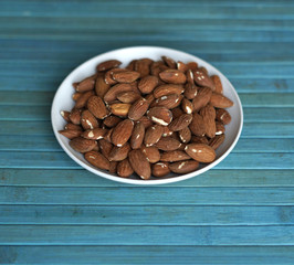 Healthy food  for background image close up almond nuts. Texture Nuts on the cup plate