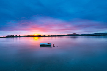 Fototapeta na wymiar Stunning sunrise over calm bay of Tauranga harbour natural background