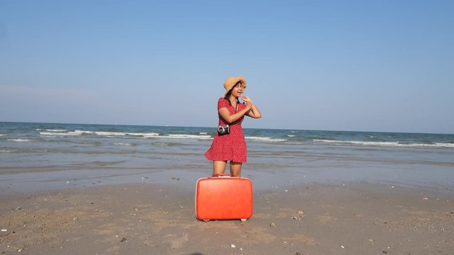 Asian woman dancing on the beach blue sky slow motion