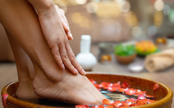 Female feet at spa pedicure procedure.Spa treatment and product for female feet and hand spa, selective and soft focus, copy space
