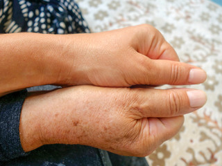 young girl is holding her grandmother's hand