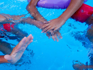 playing with children's hands in the pool