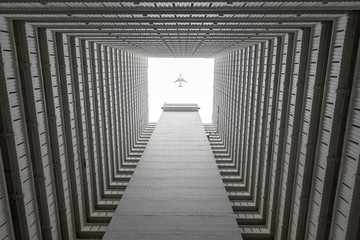 airplane flying over inner courtyard