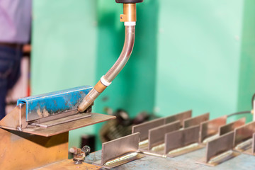 close up workpieces set up tee joint on table for by mig welding robot at factory