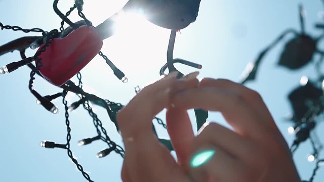Newlyweds hang lock on a love tree, close-up, slow motion