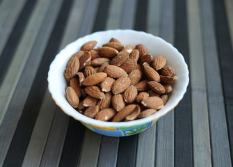 Healthy food  for background image close up almond nuts. Texture Nuts on the cup plate