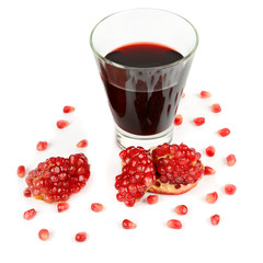 Glass of pomegranate juice with fruit isolated on white.