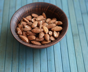 Healthy food  for background image close up almond nuts. Texture Nuts on the cup plate
