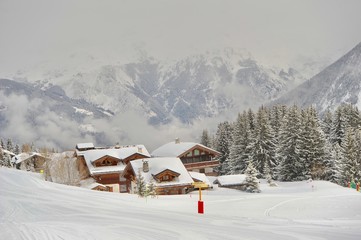 Ski resort with chalet and snow in mountain 