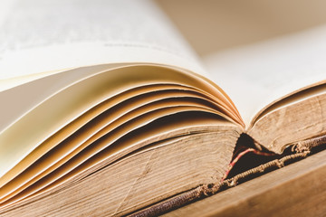 close-up of opened old book on wooden table