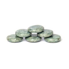 Fototapeta na wymiar Six greenish polished jadeite stone for spa massage isolated on white background