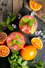 Bloody orange drink and ingredients, copy space