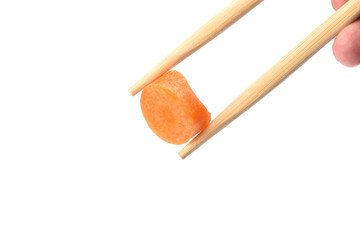 Chopsticks with a circle of ripe carrots isolated on white background.