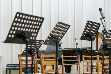 Empty seats and some instruments in music hall awaiting orchestra to come on the stage. black music...