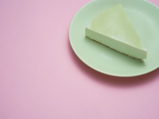 Green tea cheesecake on a green plate.