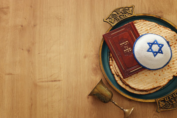 Pesah celebration concept (jewish Passover holiday). Translation for Hebrew Text over plate...