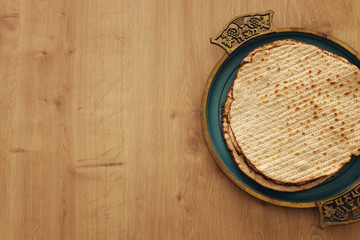 Pesah celebration concept (jewish Passover holiday). Translation for Hebrew Text over plate...