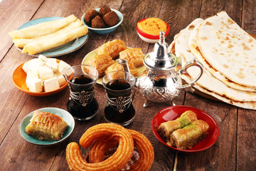 Middle eastern or arabic dishes and assorted meze, concrete rustic background. Turkish Bread or Turkish pizza. Dessert Baklava with pistachio. falafel with hommos.  Halal food. Lebanese cuisine