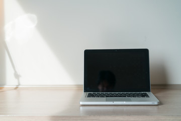 Laptop on a desk with lamp