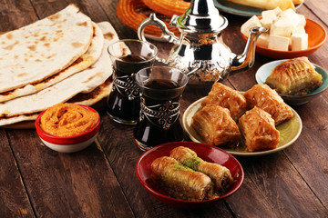 Middle eastern or arabic dishes and assorted meze, concrete rustic background. Turkish Bread or...