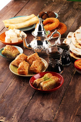 Middle eastern or arabic dishes and assorted meze, concrete rustic background. Turkish Bread or Turkish pizza. Dessert Baklava with pistachio. falafel with hommos.  Halal food. Lebanese cuisine