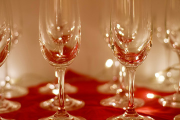bright sparkling wine glasses in front of red lightning decoration