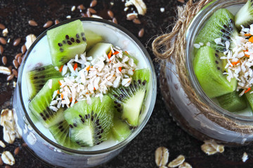 Healthy breakfast or snack. White coconut yogurt with granola and kiwi. Probiotics. Keto diet. Keto breakfast. Keto dessert.