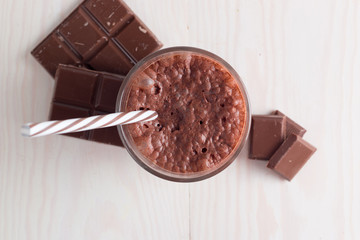 Chocolate, coffee, milk, banana shake on wooden background. Smoothie with mint. Milkshake. Protein diet. Healthy food and drink concept.