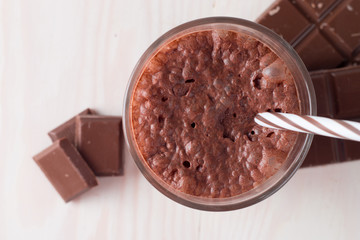 Chocolate, coffee, milk, banana shake on wooden background. Smoothie with mint. Milkshake. Protein diet. Healthy food and drink concept.